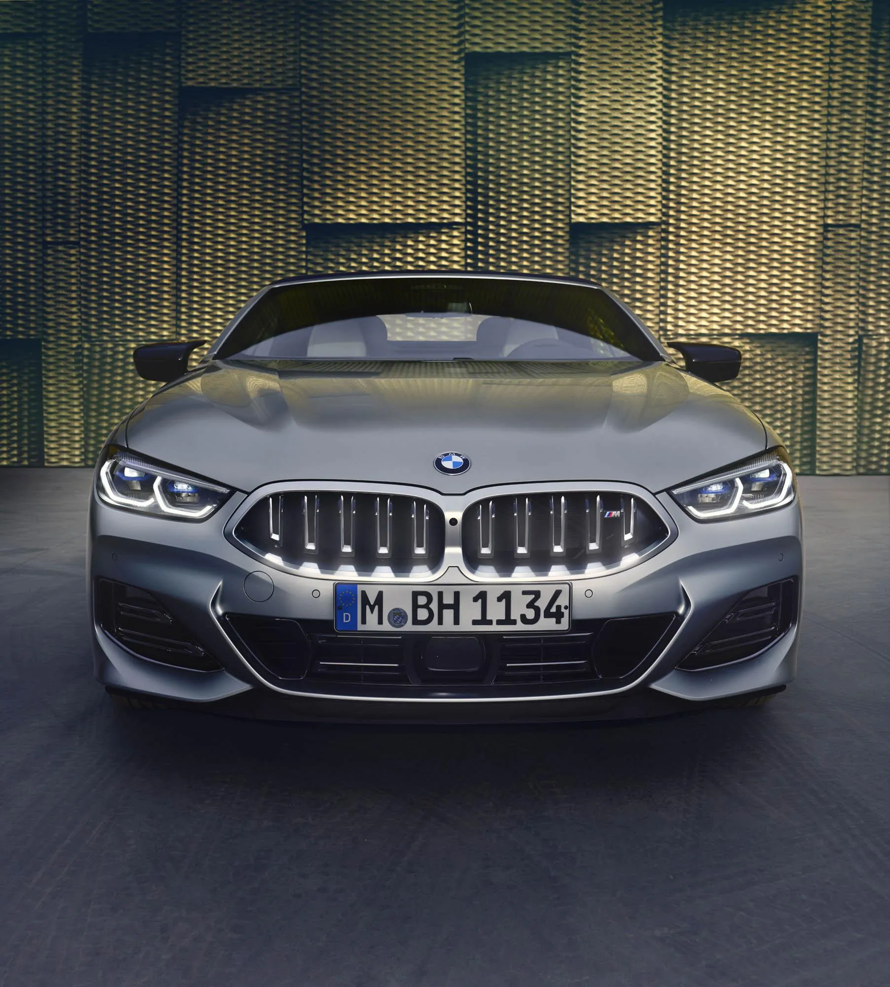 Silver Bmw with Gold Wall Background Front View Wallpaper