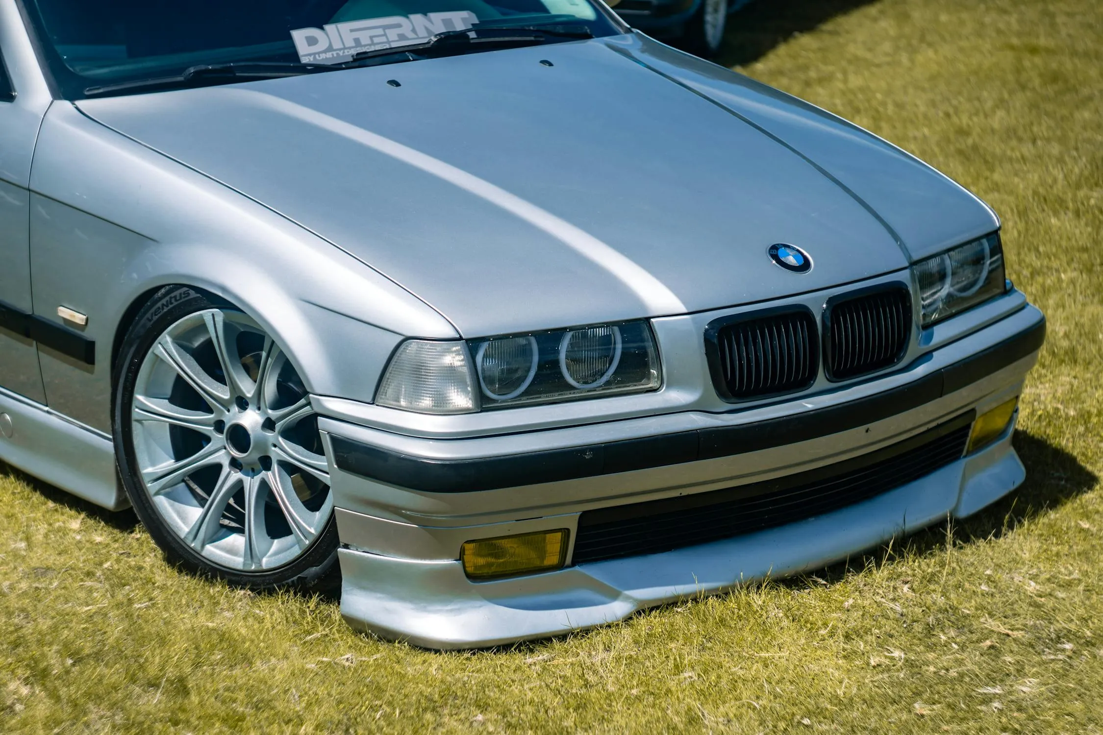 Silver Classic Bmw Parked on Grass in Bright Daylight