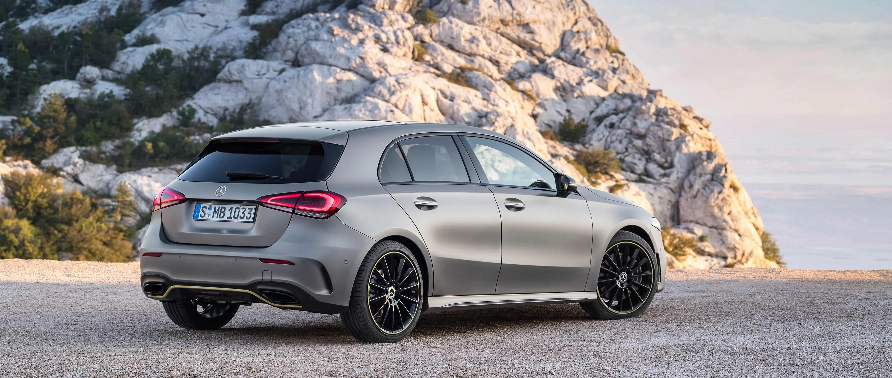 Silver Mercedes Benz Hatchback Parked by the Sea at Sunset