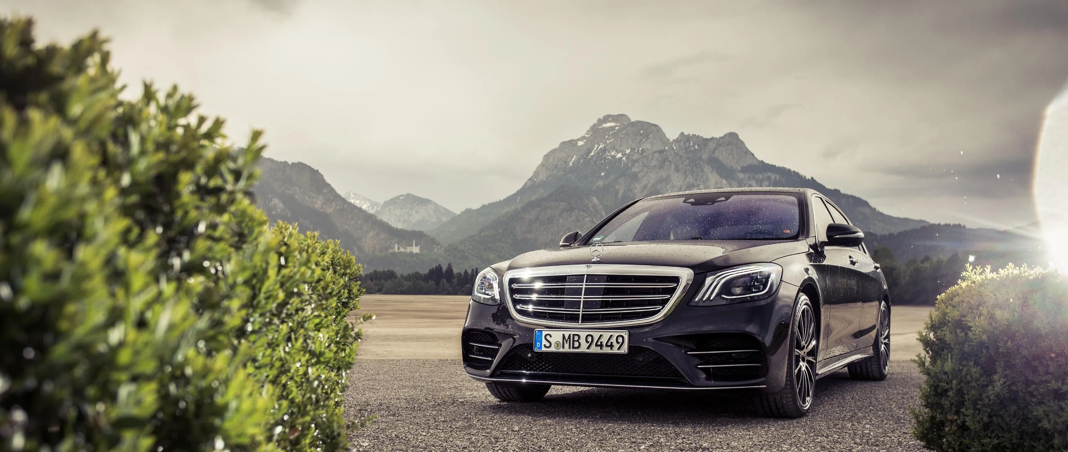 Silver Mercedes Benz Luxury Sedan Parked by Mountain Landscape