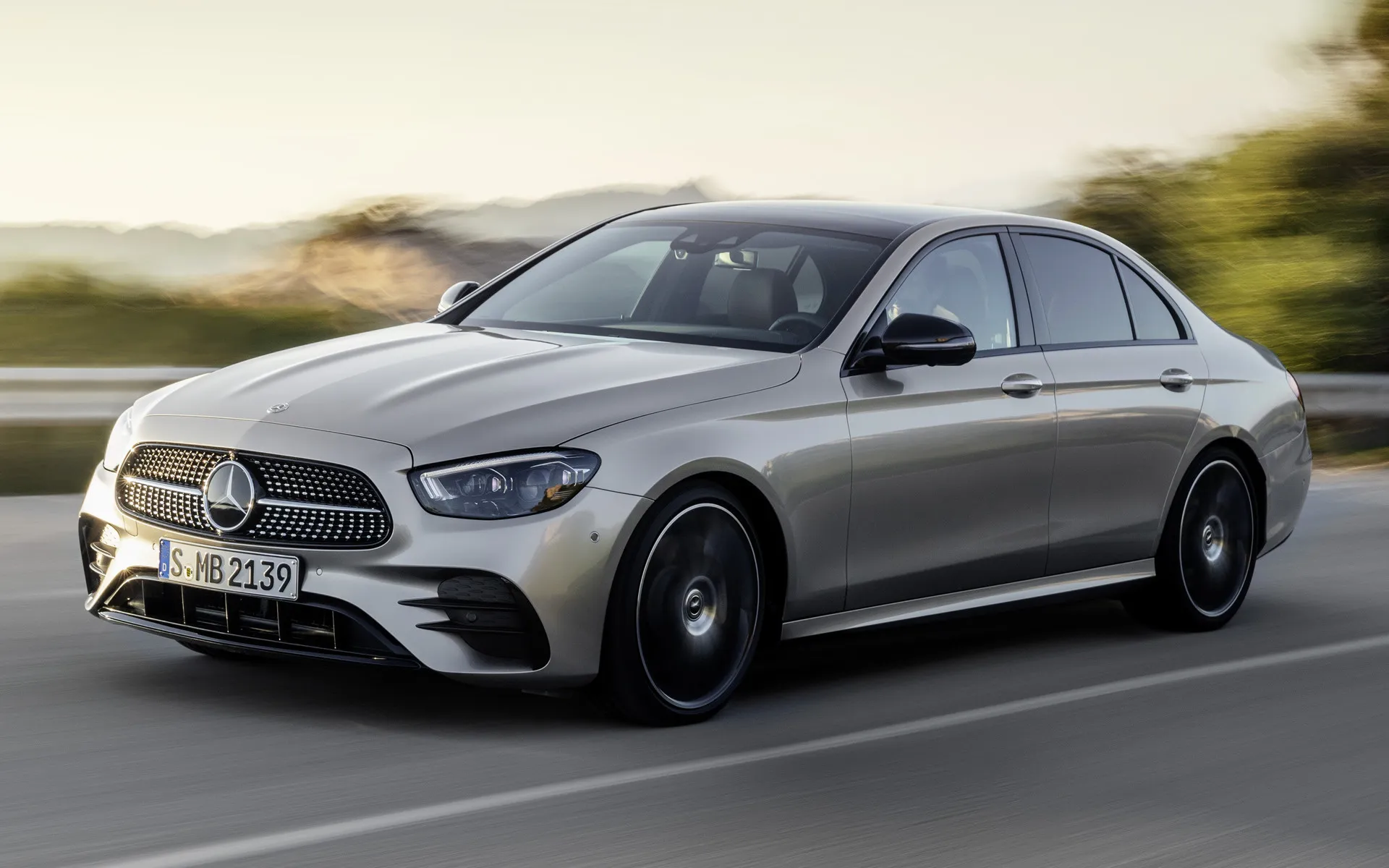 Silver Mercedes Benz Sedan Driving on Open Highway Wallpaper