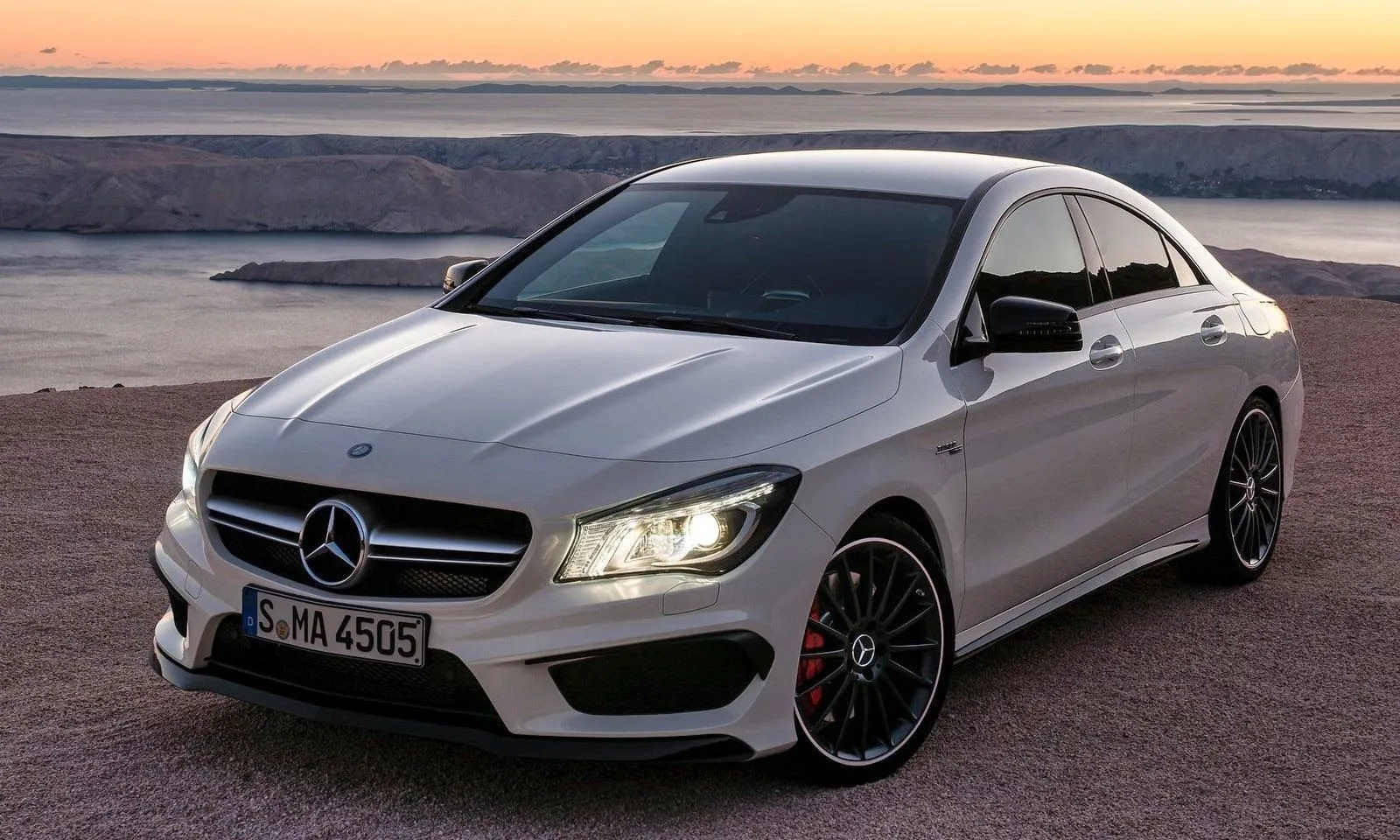 Silver Mercedes Benz Sedan Parked by the Ocean at Sunset