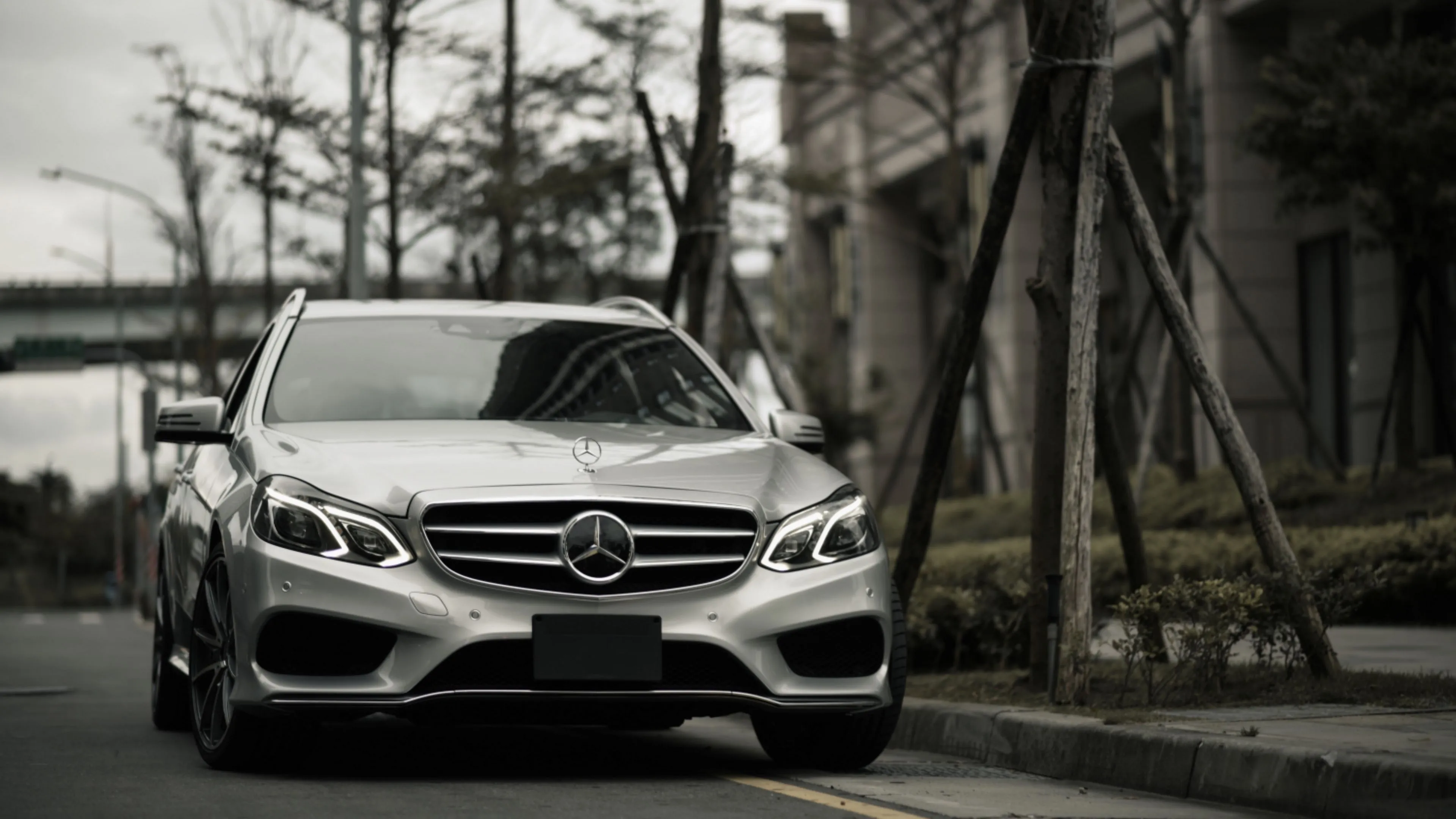 Silver Mercedes Benz Sedan Parked in Blurred city background