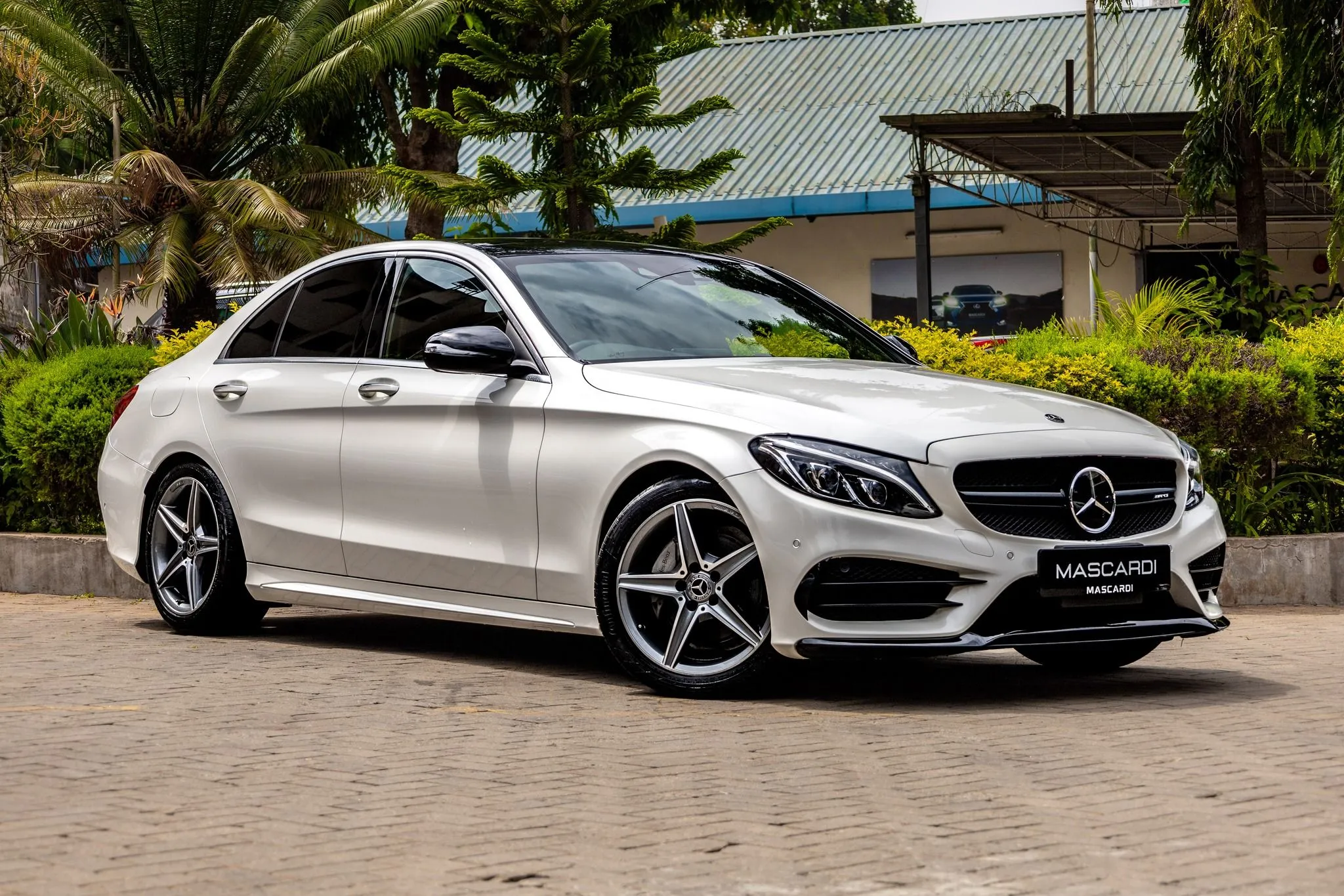 Silver Mercedes Benz Sedan Parked in Front of a House