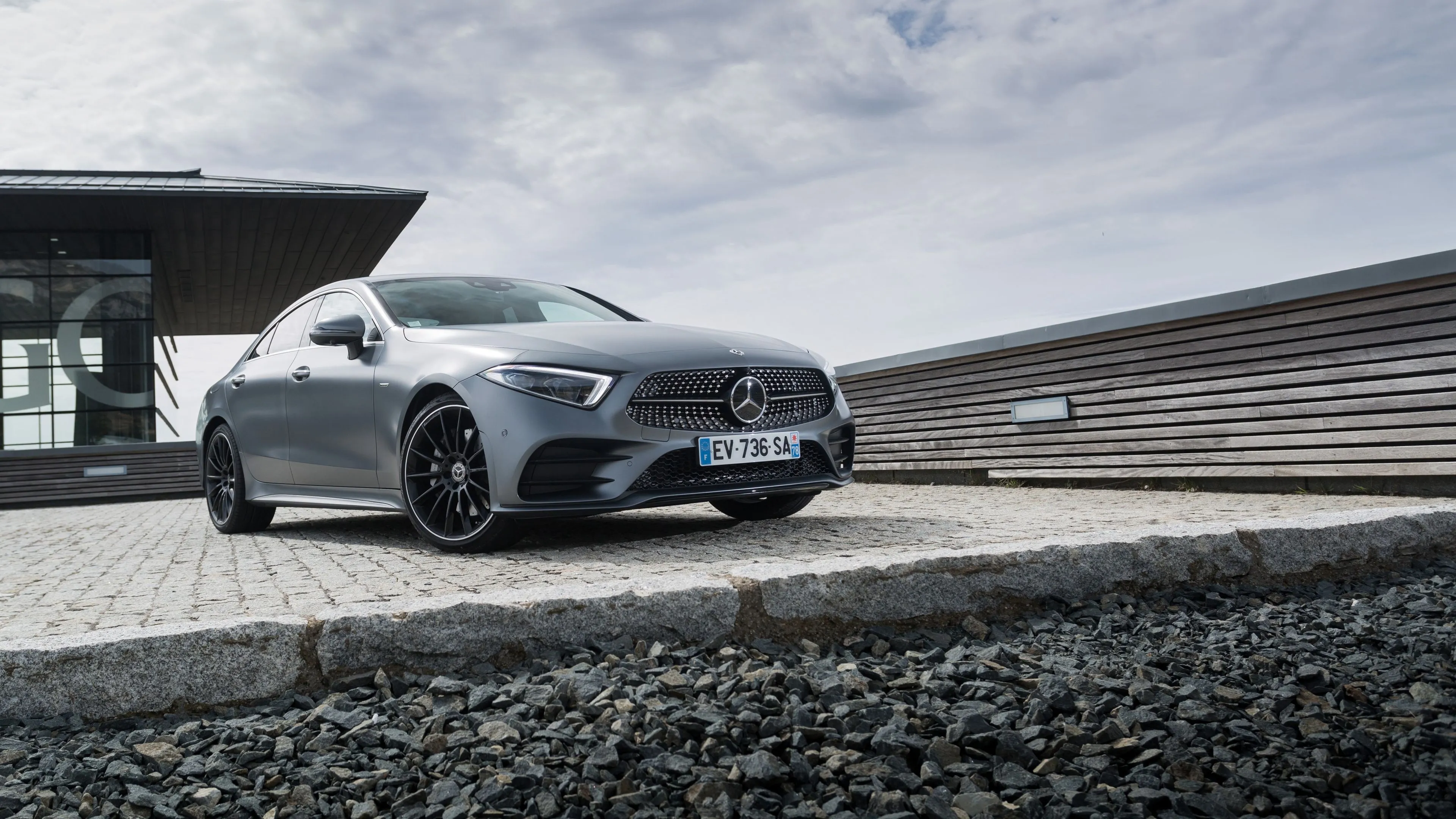 Silver Mercedes Benz Sedan Parked Near Concrete Wall