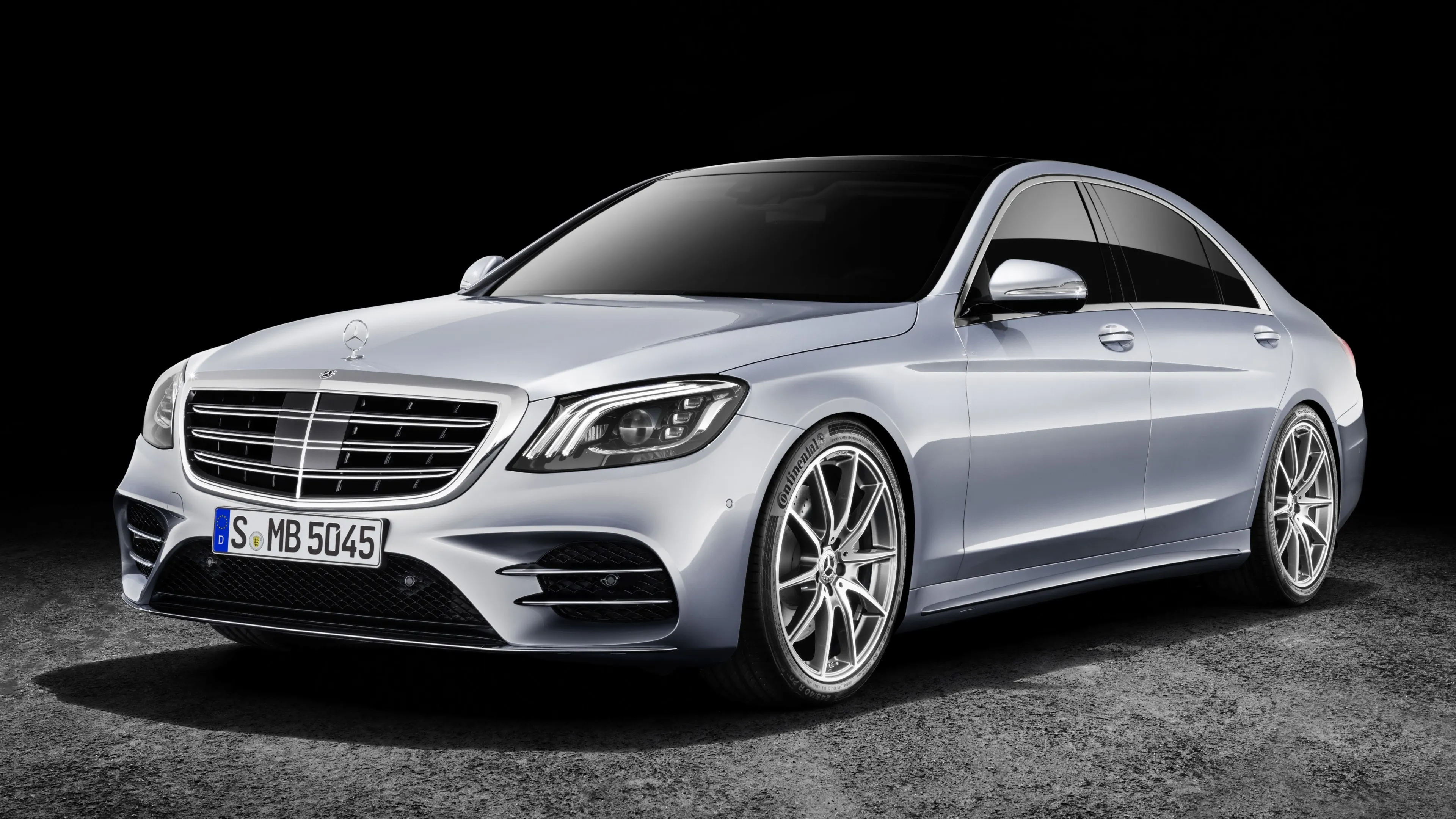Silver Mercedes Benz Sedan Parked on Gravel Surface