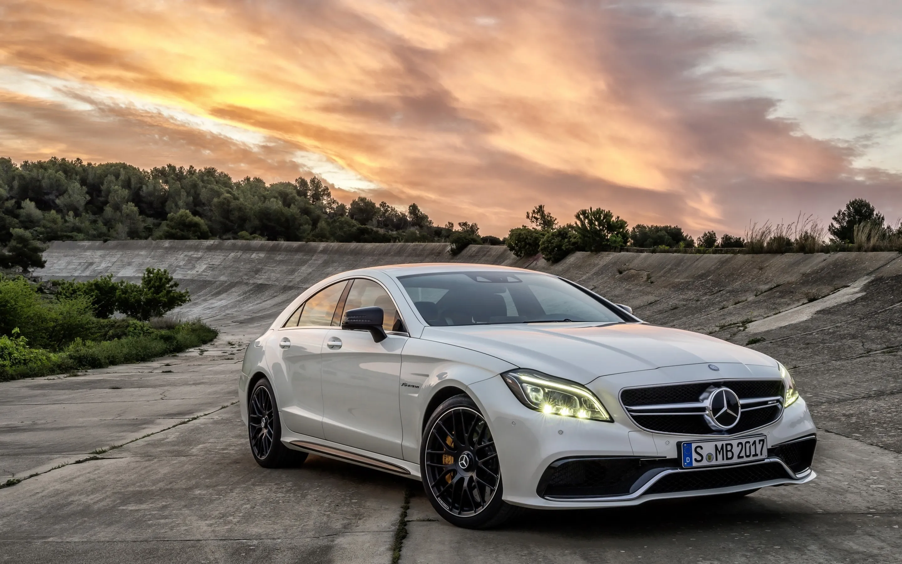 Silver Mercedes Benz Sedan Parked with Scenic Sunset View