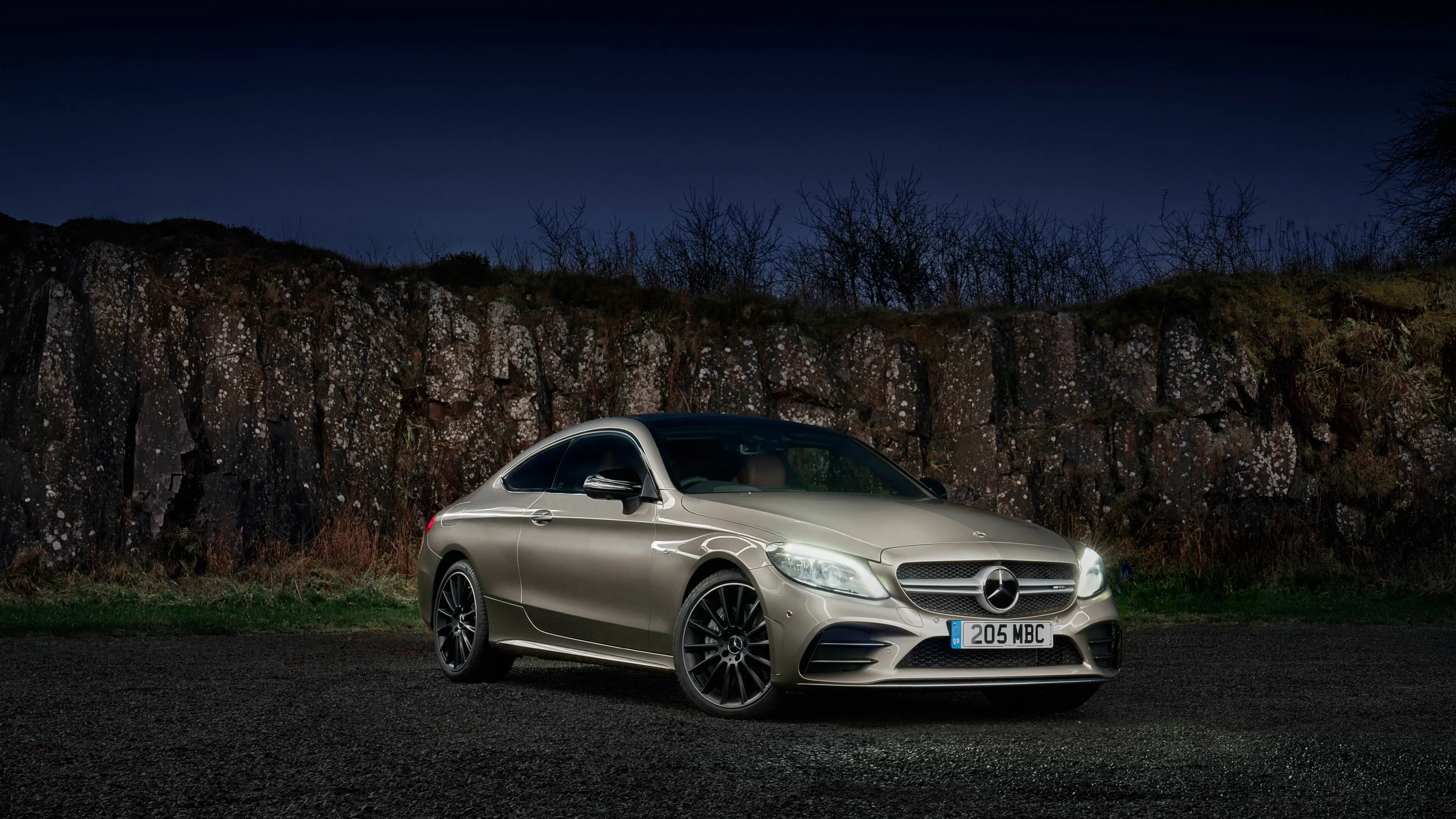 Silver Mercedes Benz Sports Car Parked Near Rocks image