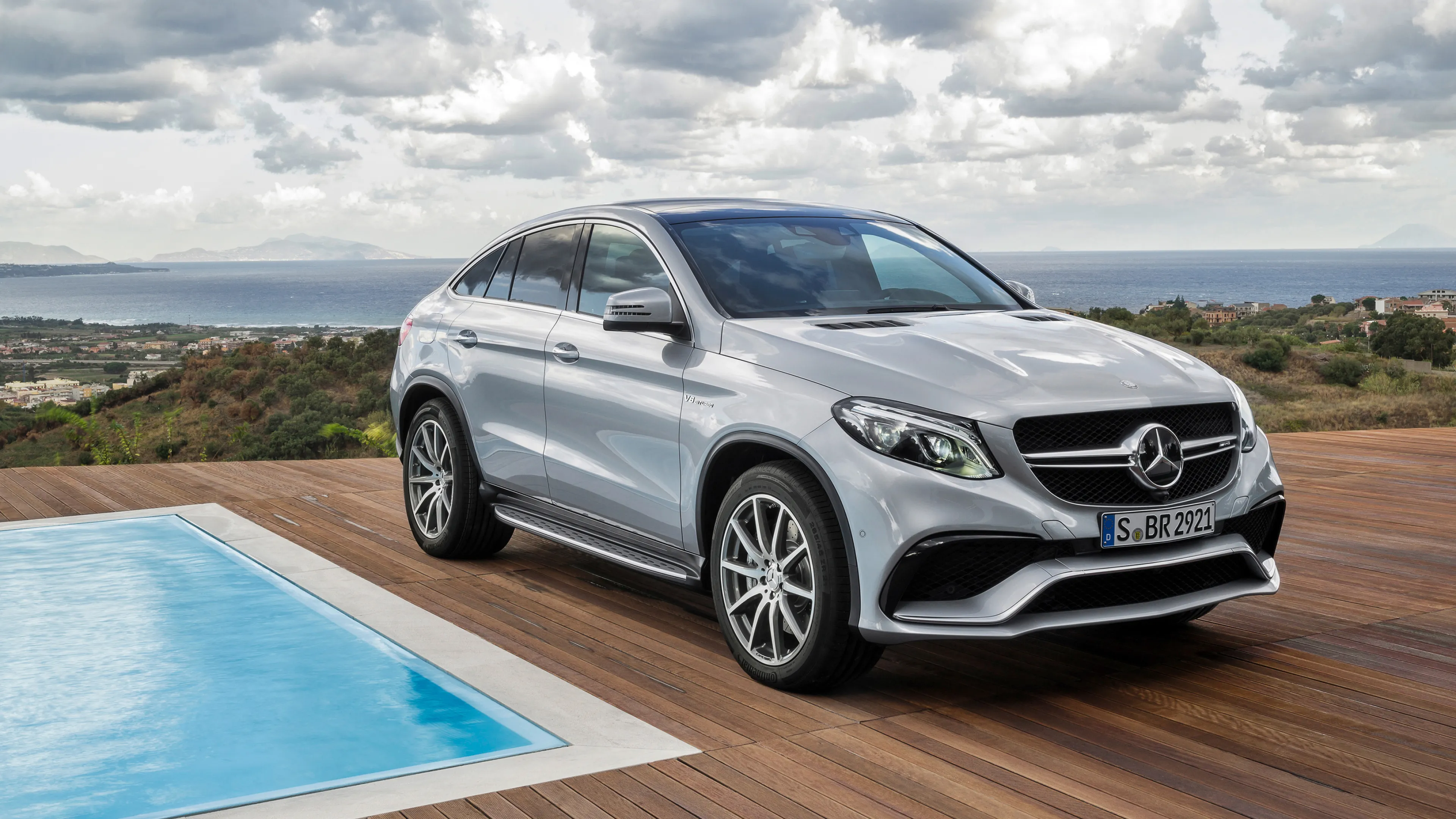 Silver Mercedes Benz SUV Parked by a Swimming Pool