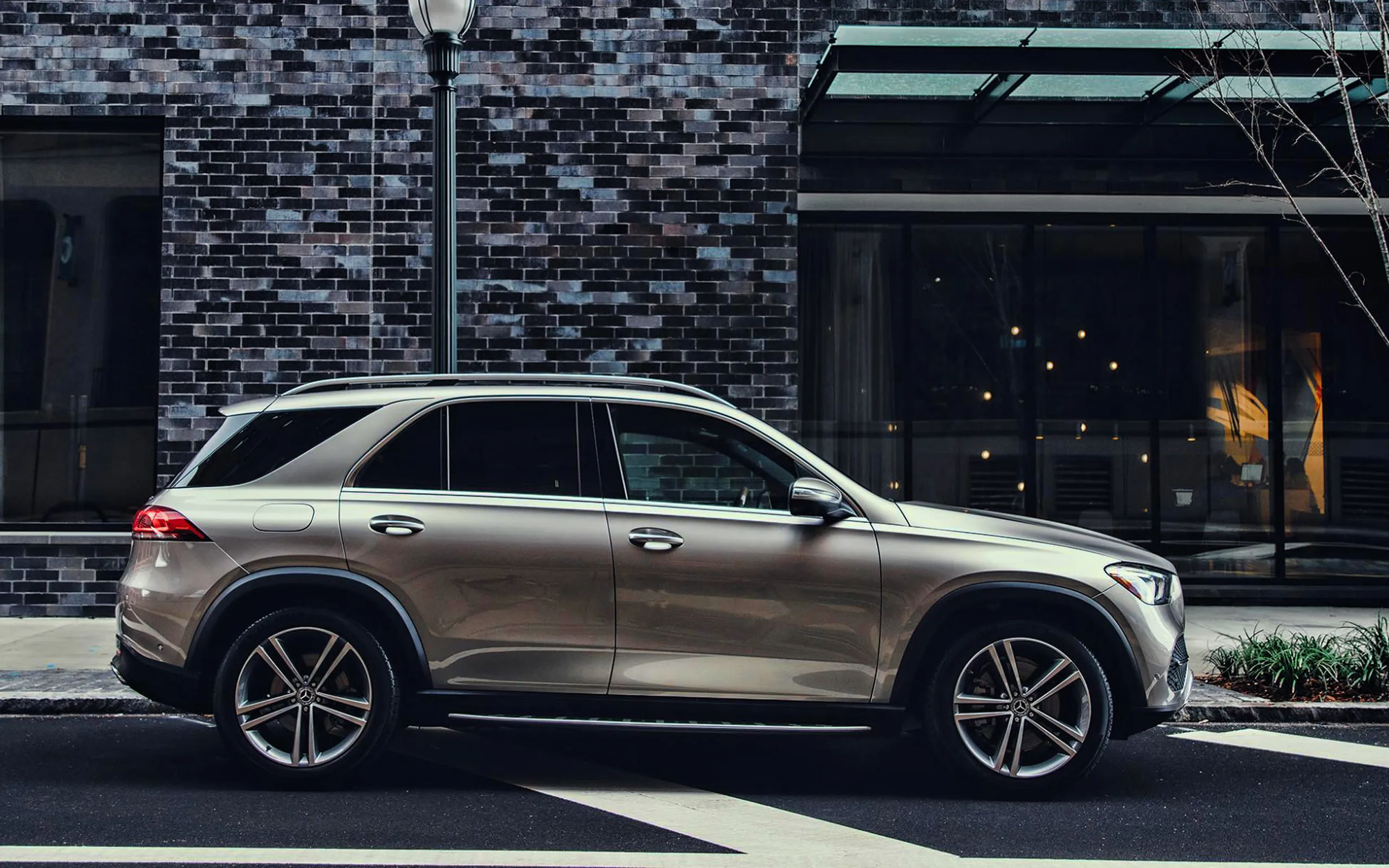 Silver Mercedes Benz SUV Parked Outside Modern Building