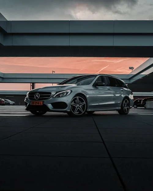 Silver Mercedes in Sunset Light Under Parking Structure