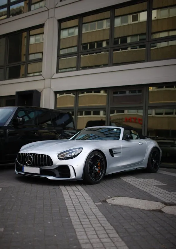 Silver Mercedes sports car parked on urban street image