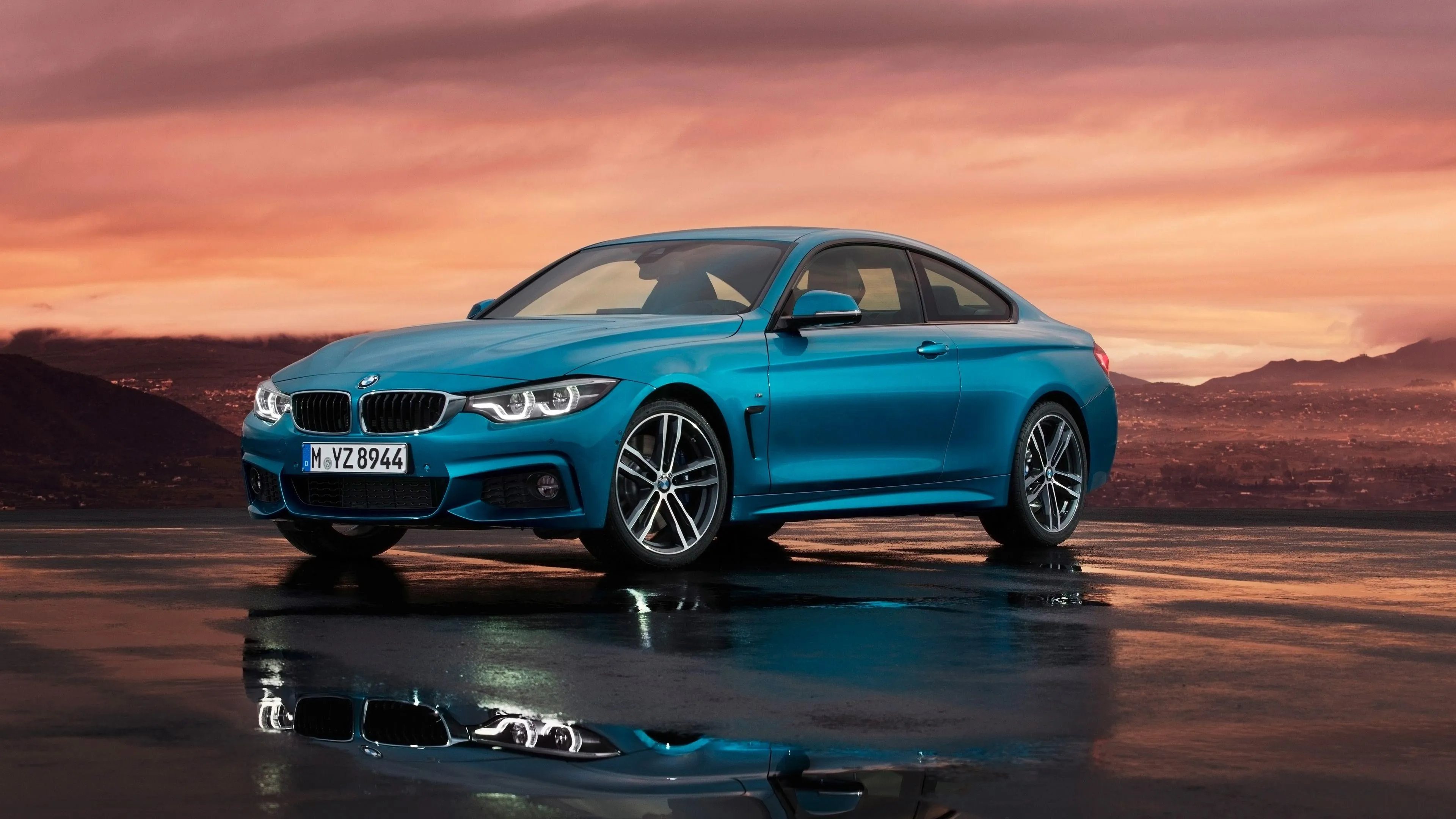 Sky Blue Bmw Coupe Parked on an Open Road at Sunset