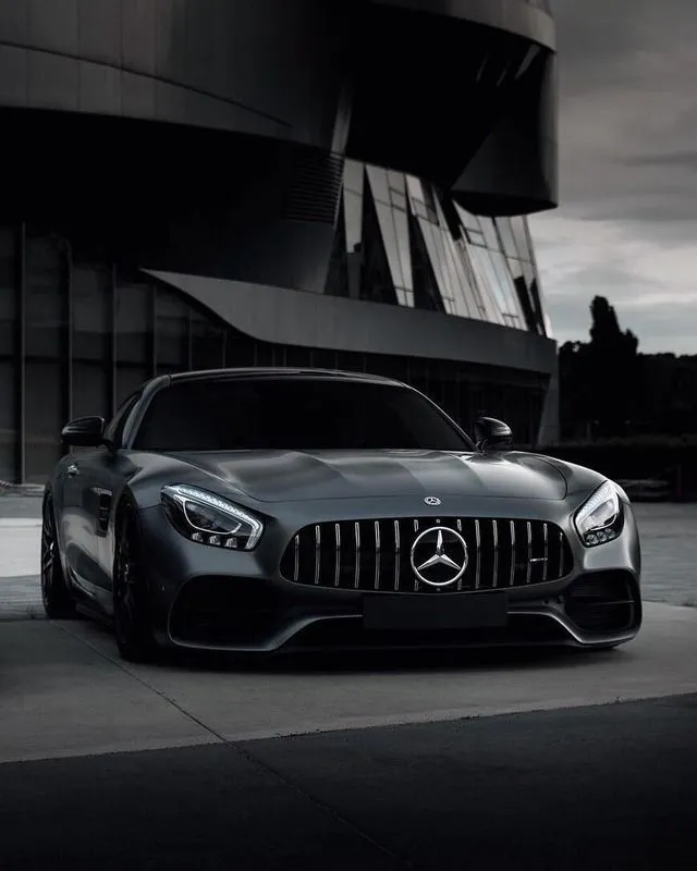 Sleek Black Mercedes AMG Parked in Front of Modern Building