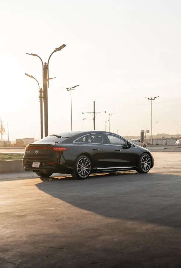 Sleek Black Mercedes Benz Sedan Parked in Urban Sunset Setting