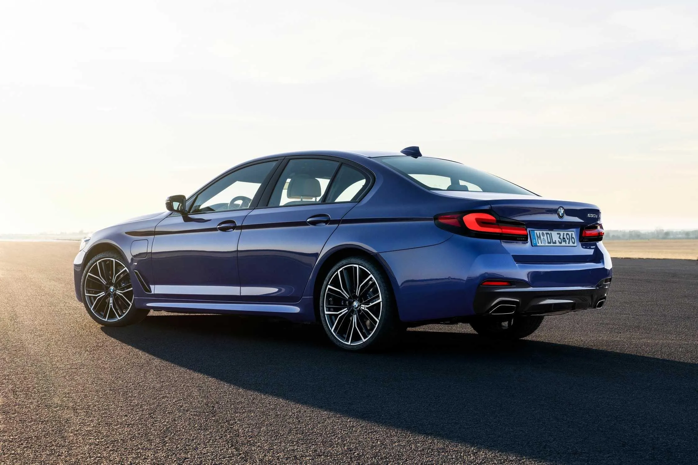 Sleek Blue Bmw Coupe Driving Into the Sunset Light 4K