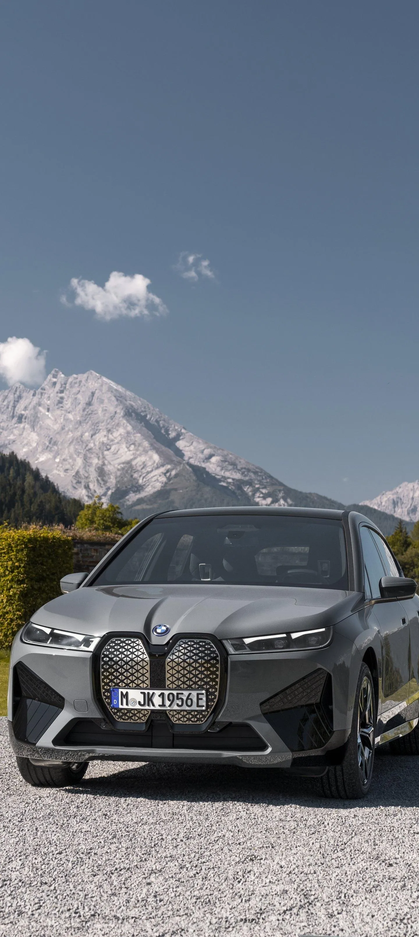 Sleek Bmw Parked Near Mountain Range Under Blue Sky