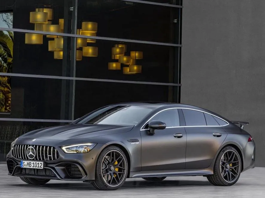 Sleek silver Mercedes AMG coupe parked near modern wall