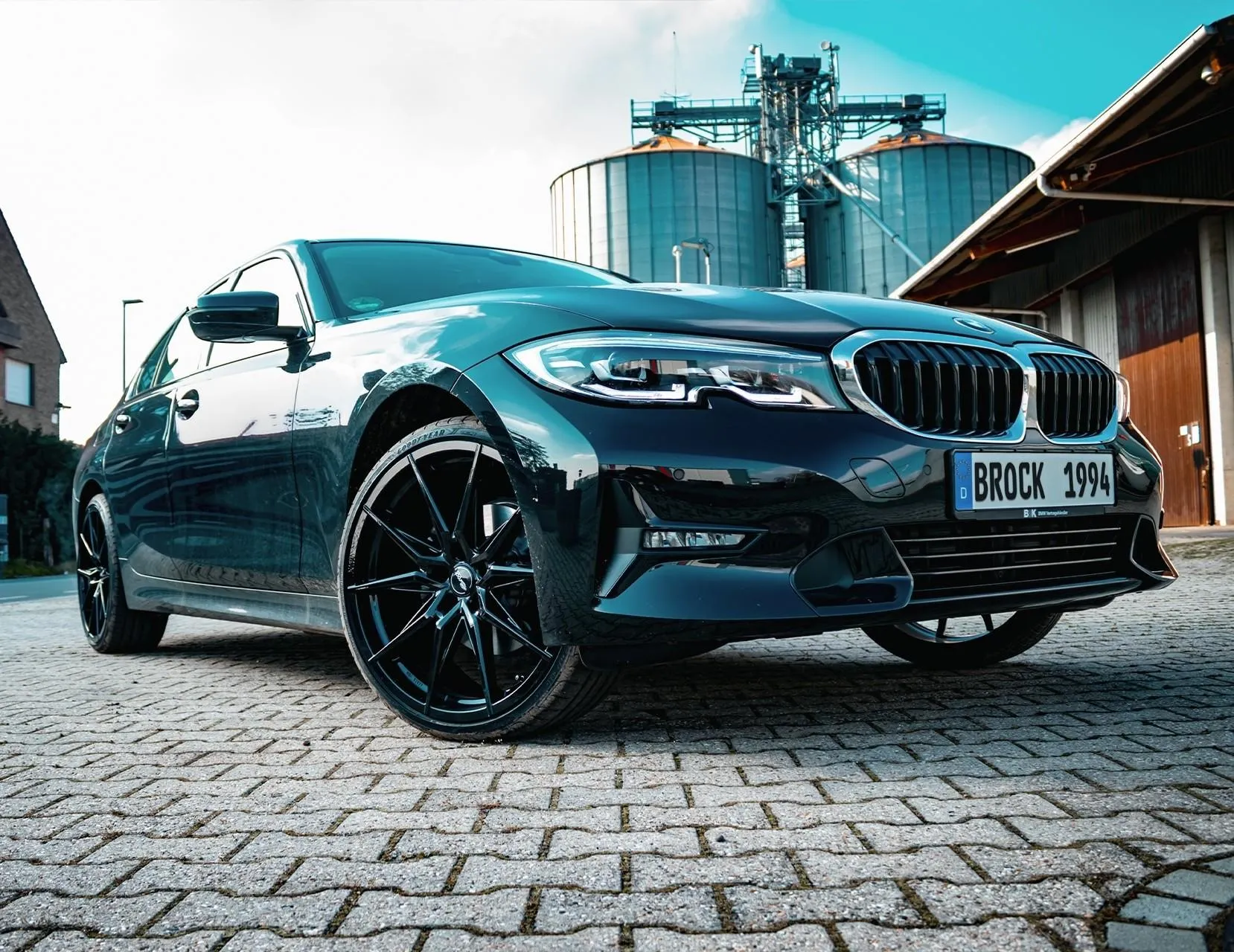 Sporty Blue Bmw Parked Outside on a Sunny Day Wallpaper