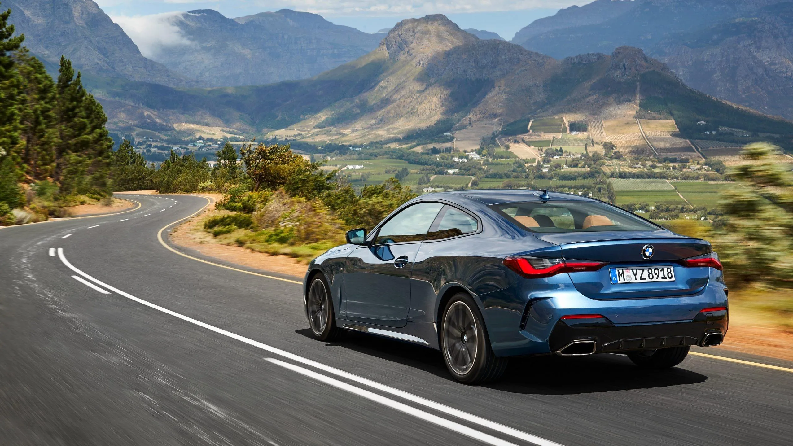 Sporty Bmw Driving on a Scenic Mountain Road Hd Image
