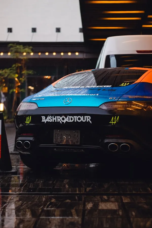 Sporty car parked under bright city lights at night