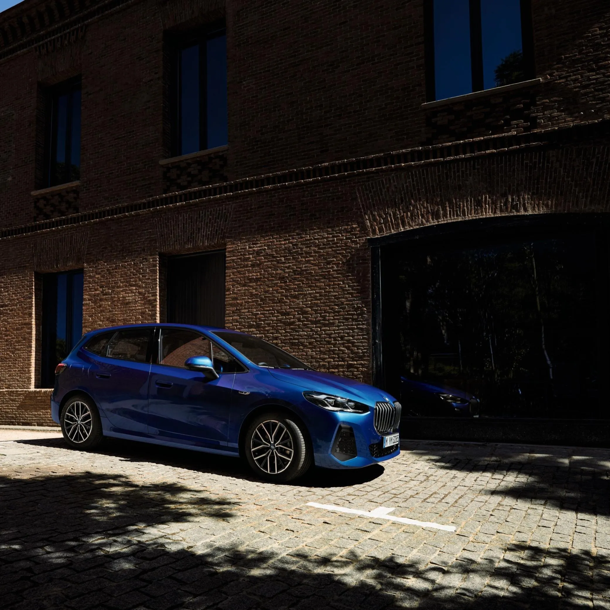 Stunning Blue Bmw Parked Under Shadow and Light Wallpaper