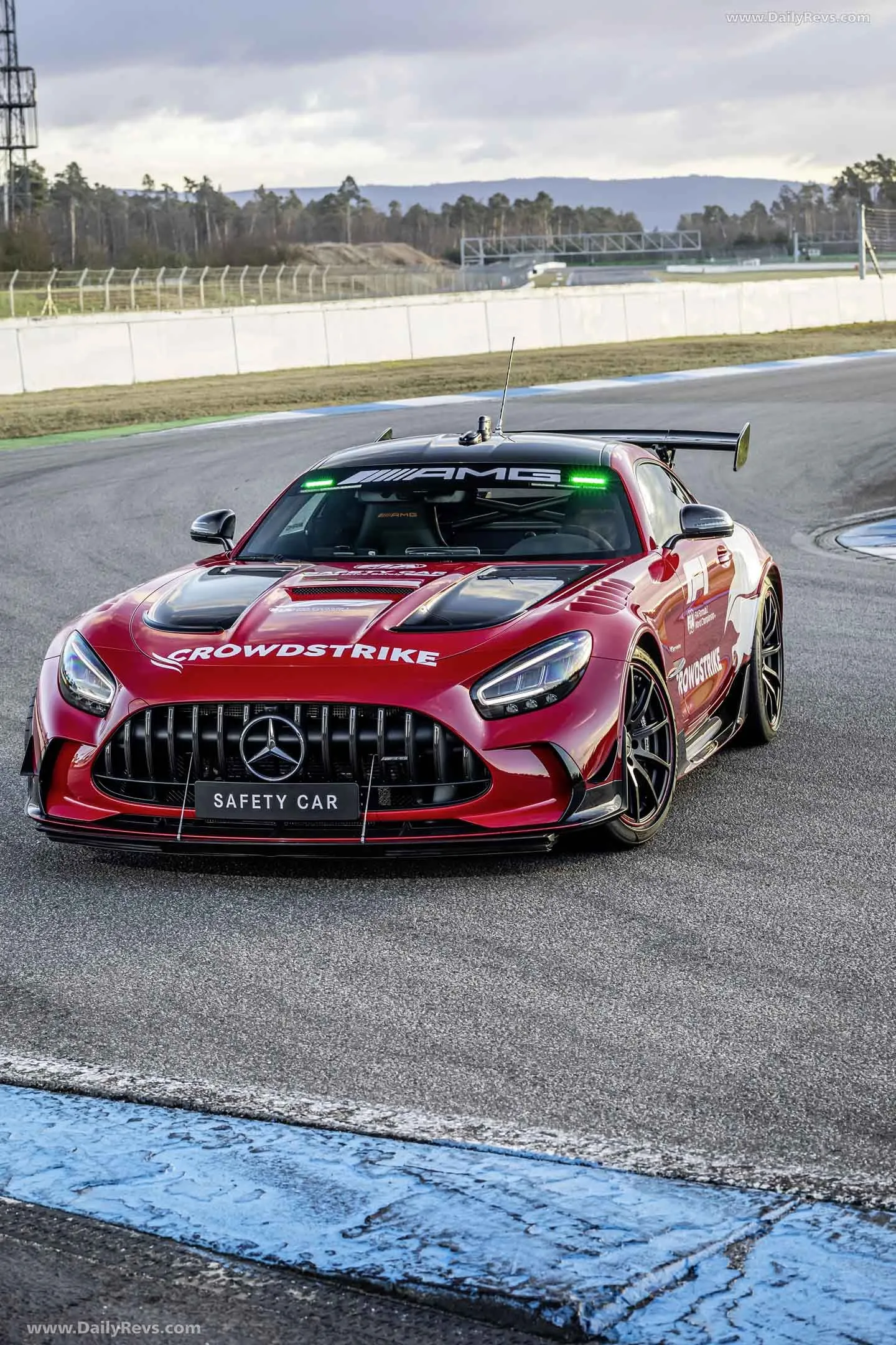 Stunning Red Mercedes Racing Car On A Track Curve image