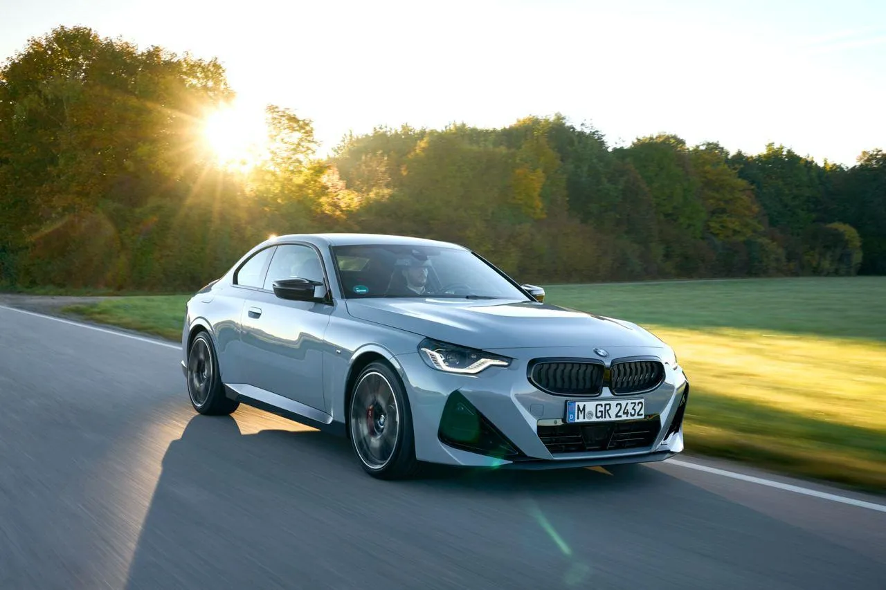 Stunning Silver Bmw Driving at Sunset on a Road in Forest