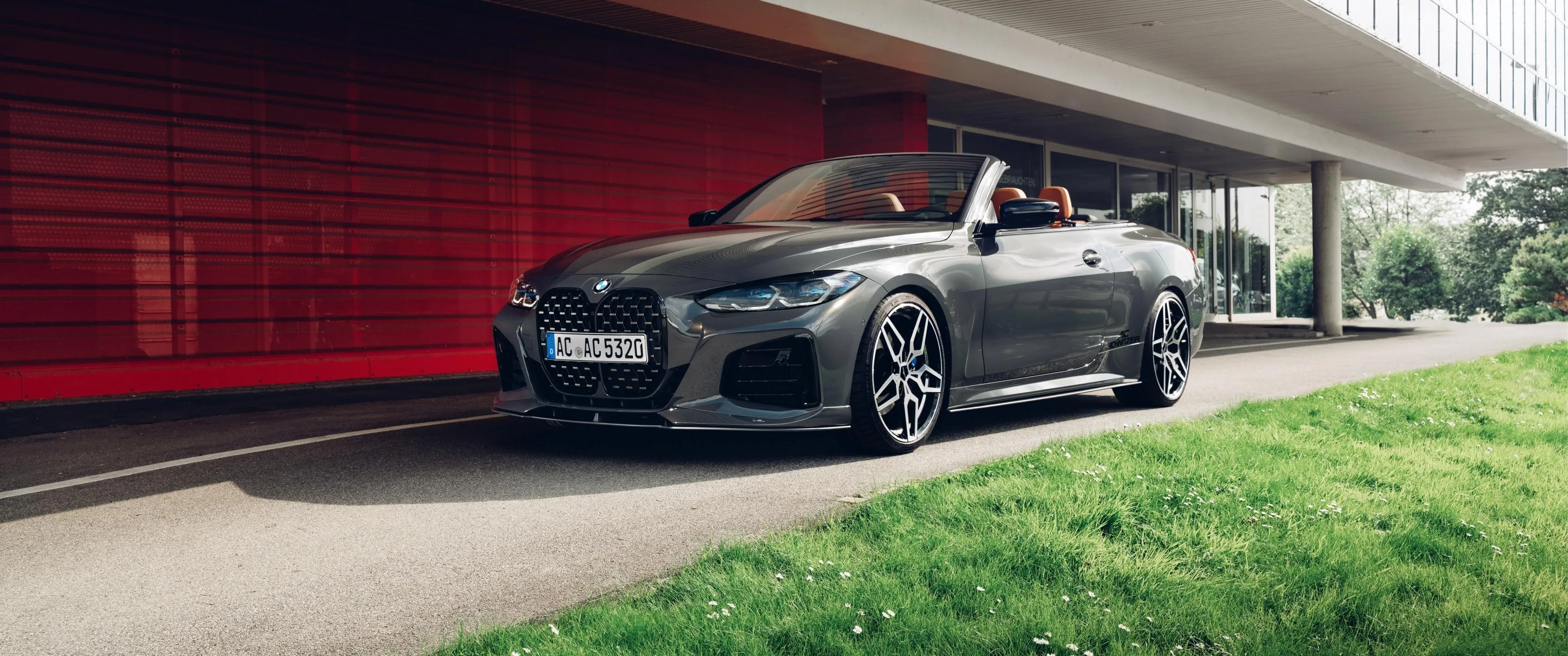 Stylish Bmw Sedan Under Modern Canopy Near Grass Field