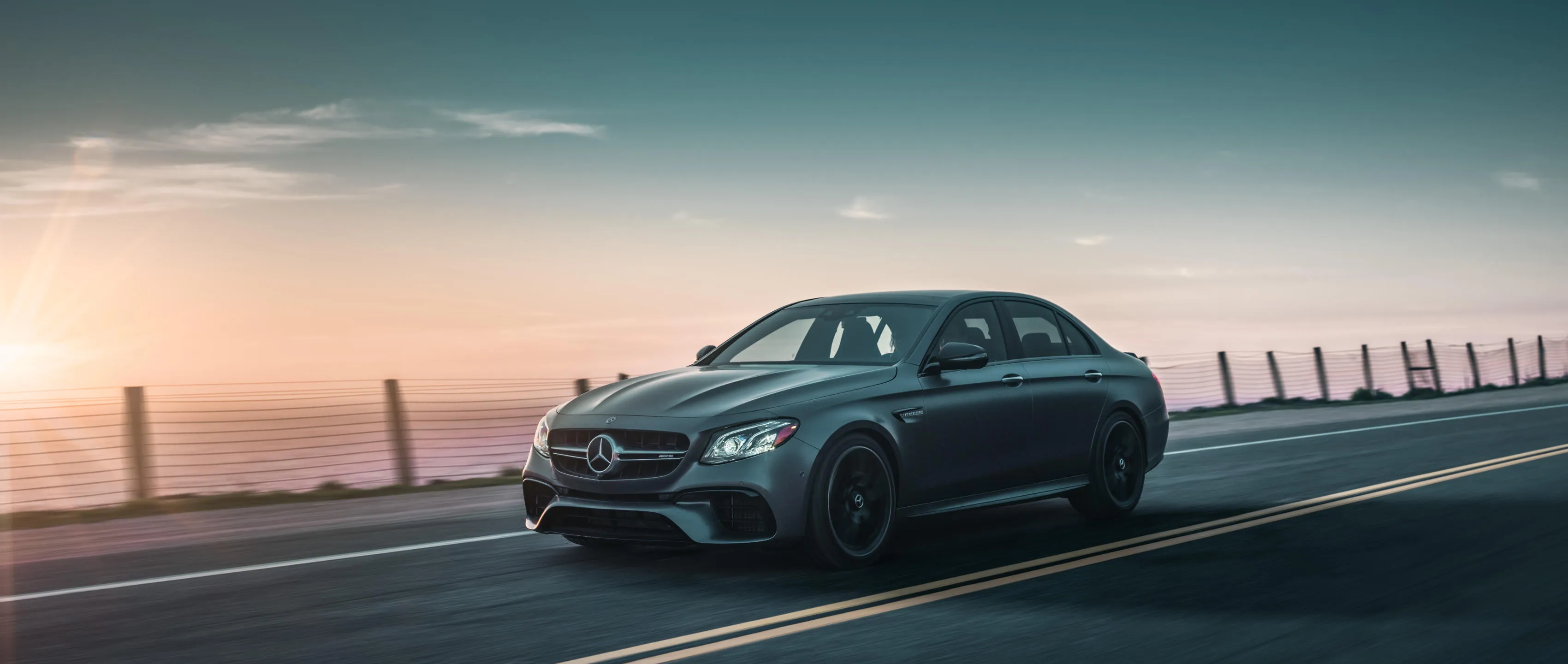 Stylish Mercedes Benz Driving at Sunset free Wallpaper