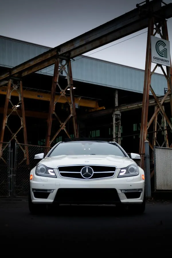Stylish White Mercedes Benz in Industrial Warehouse Area