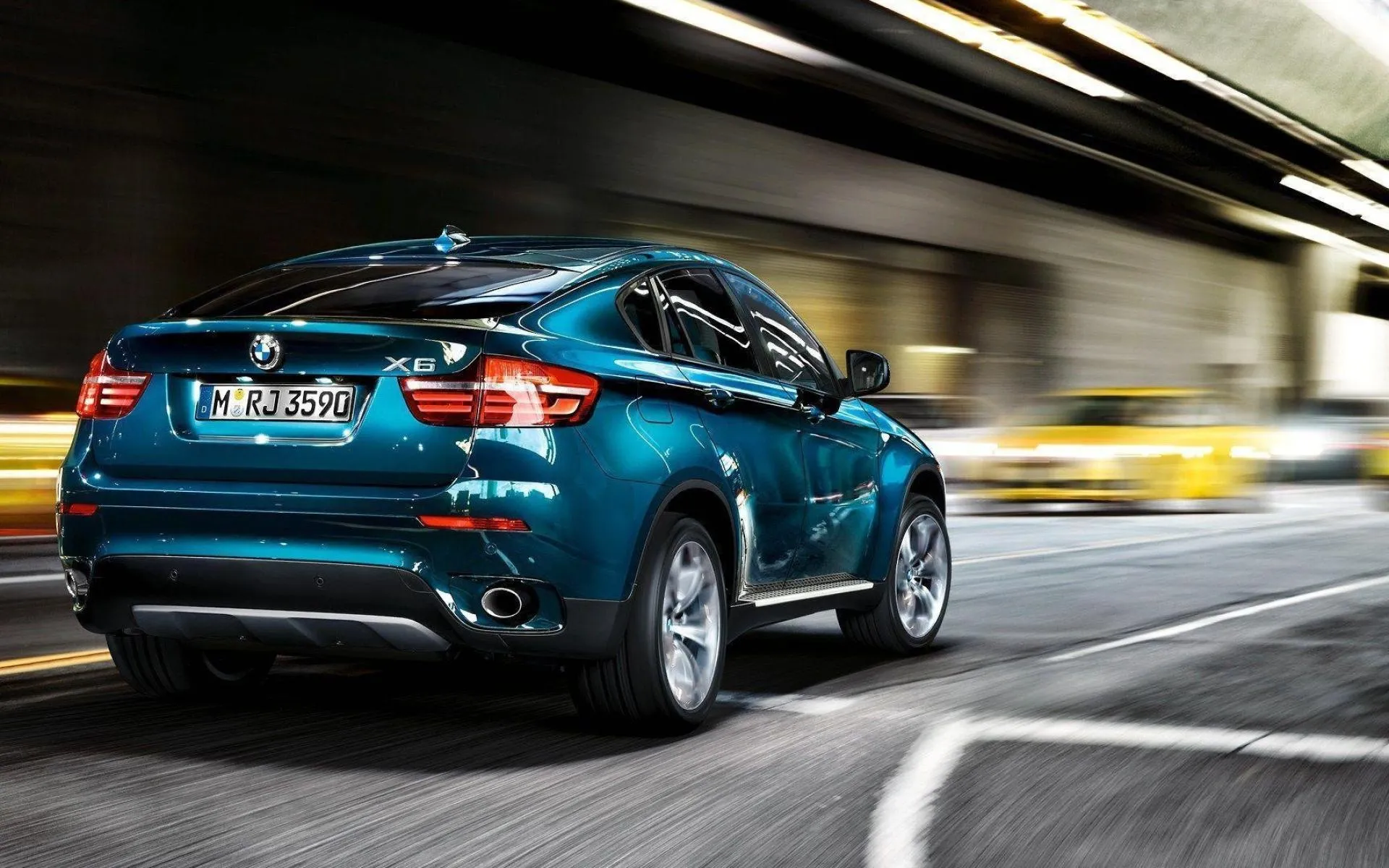 Teal Bmw Suv in Motion Driving Fast Through City Tunnel