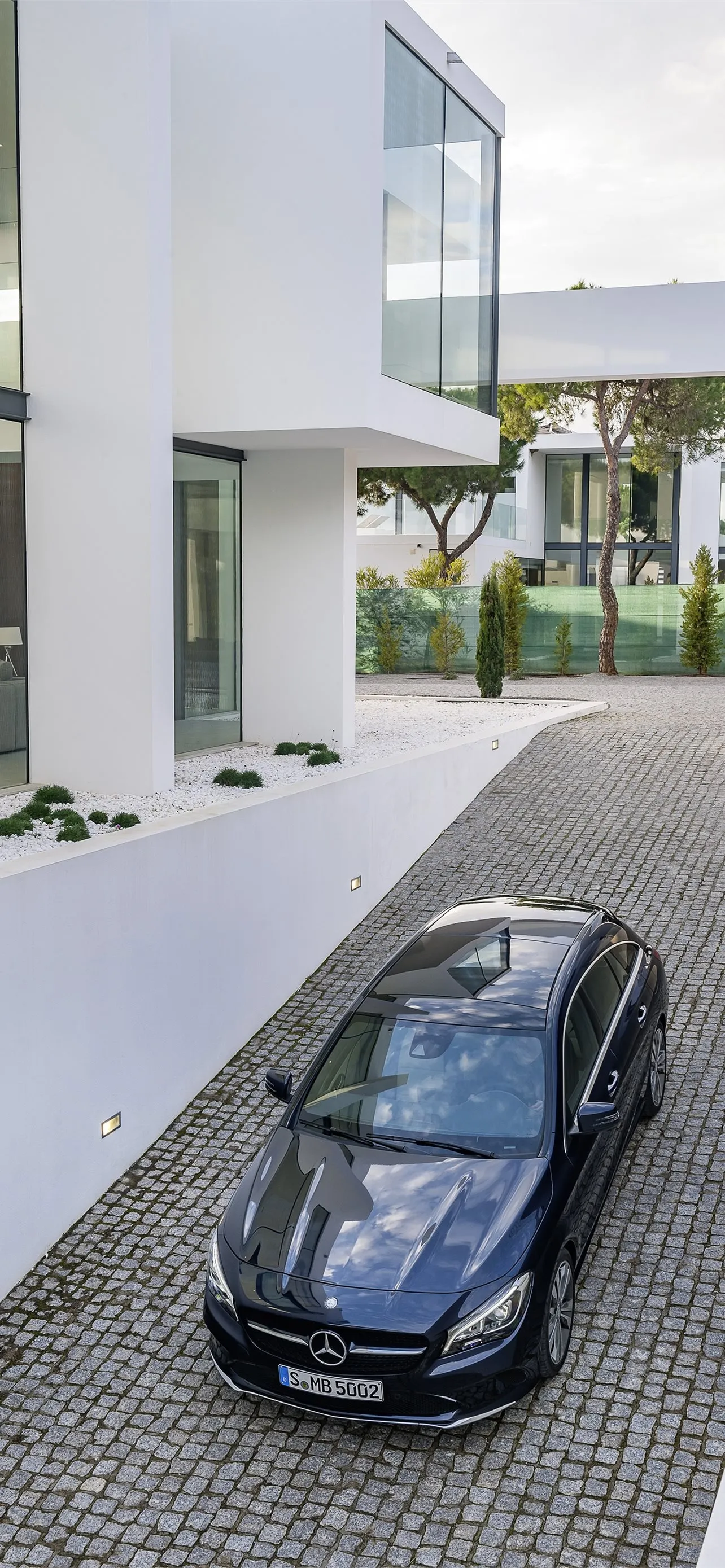 Top Down View of Black Mercedes at White Villa Wallpaper