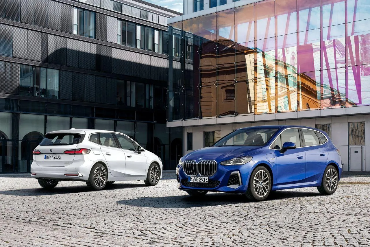 Two Bmw Cars Parked Near a Modern Urban Building