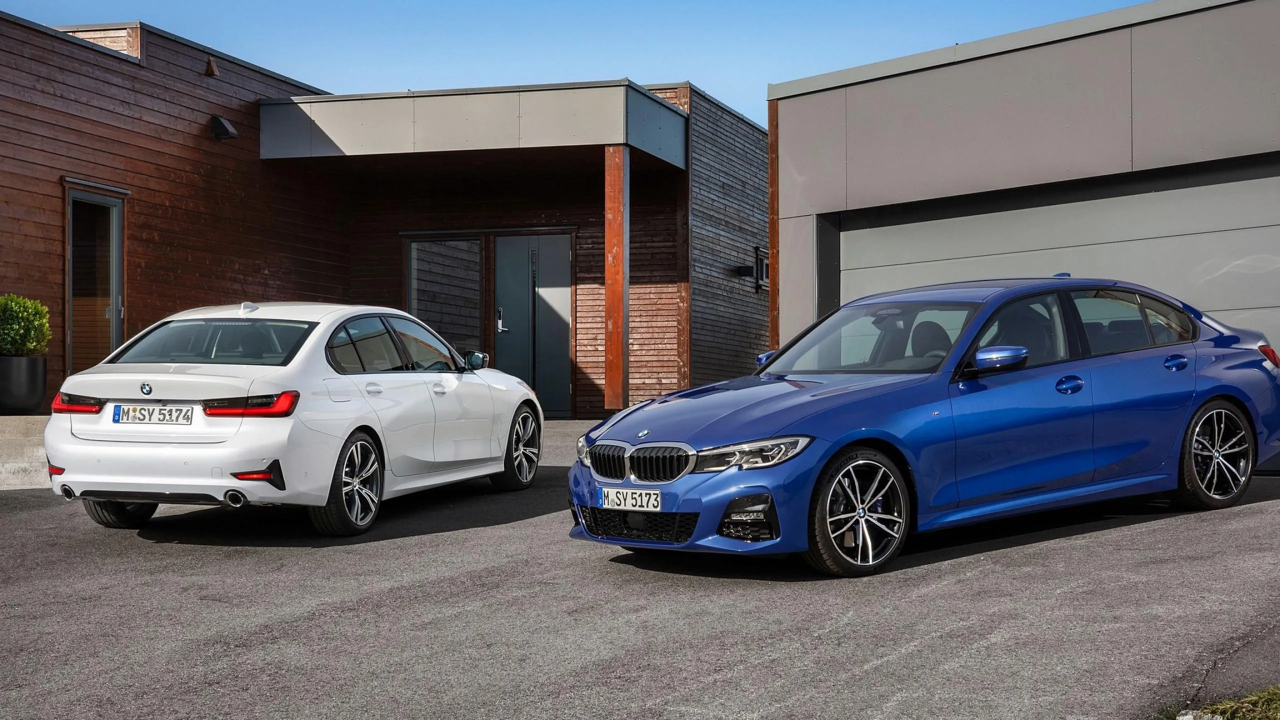 Two Bmw Cars Parked Outside a Modern House Free Hd Image