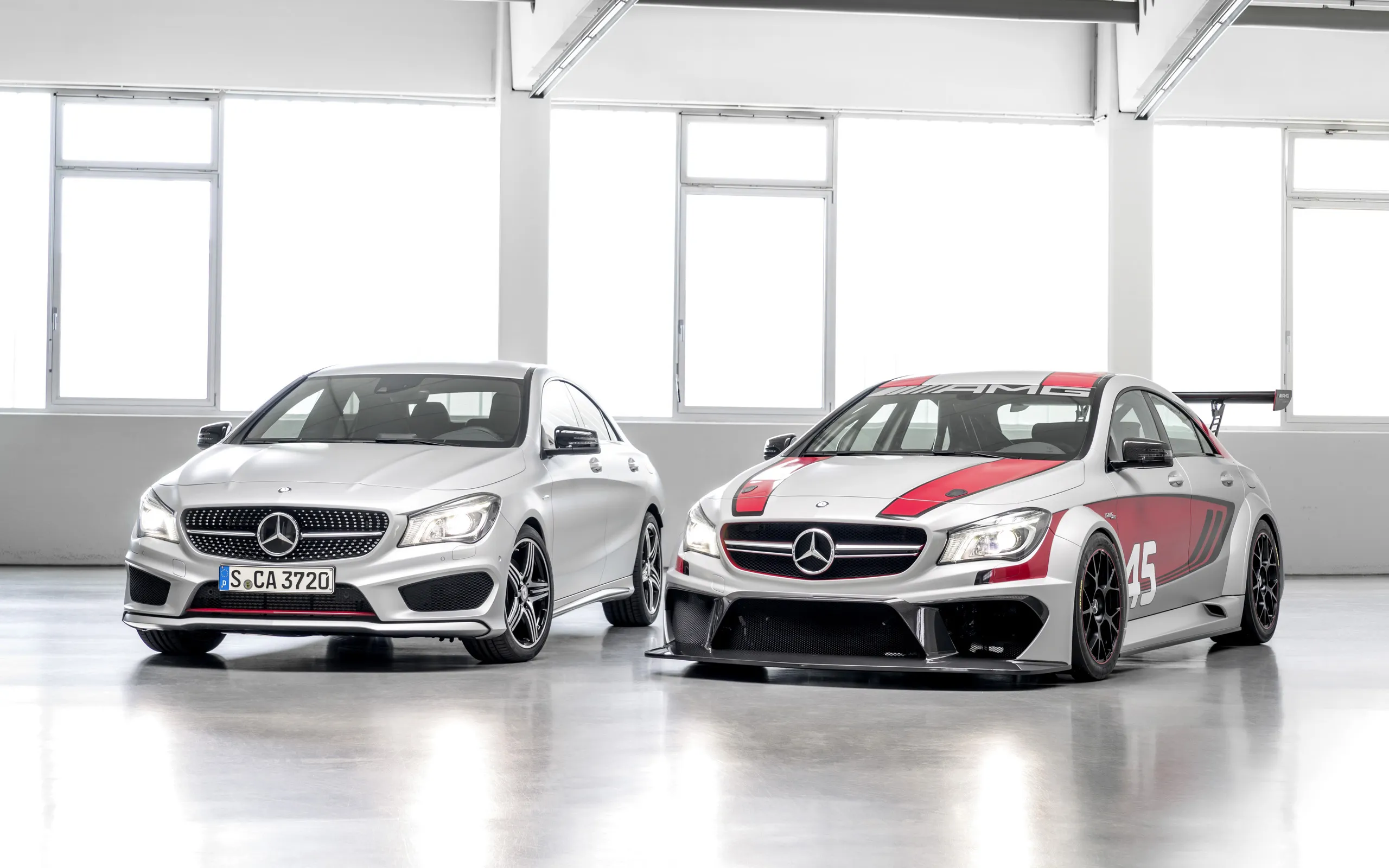 Two Mercedes Benz Cars Parked in Bright Garage Wallpaper