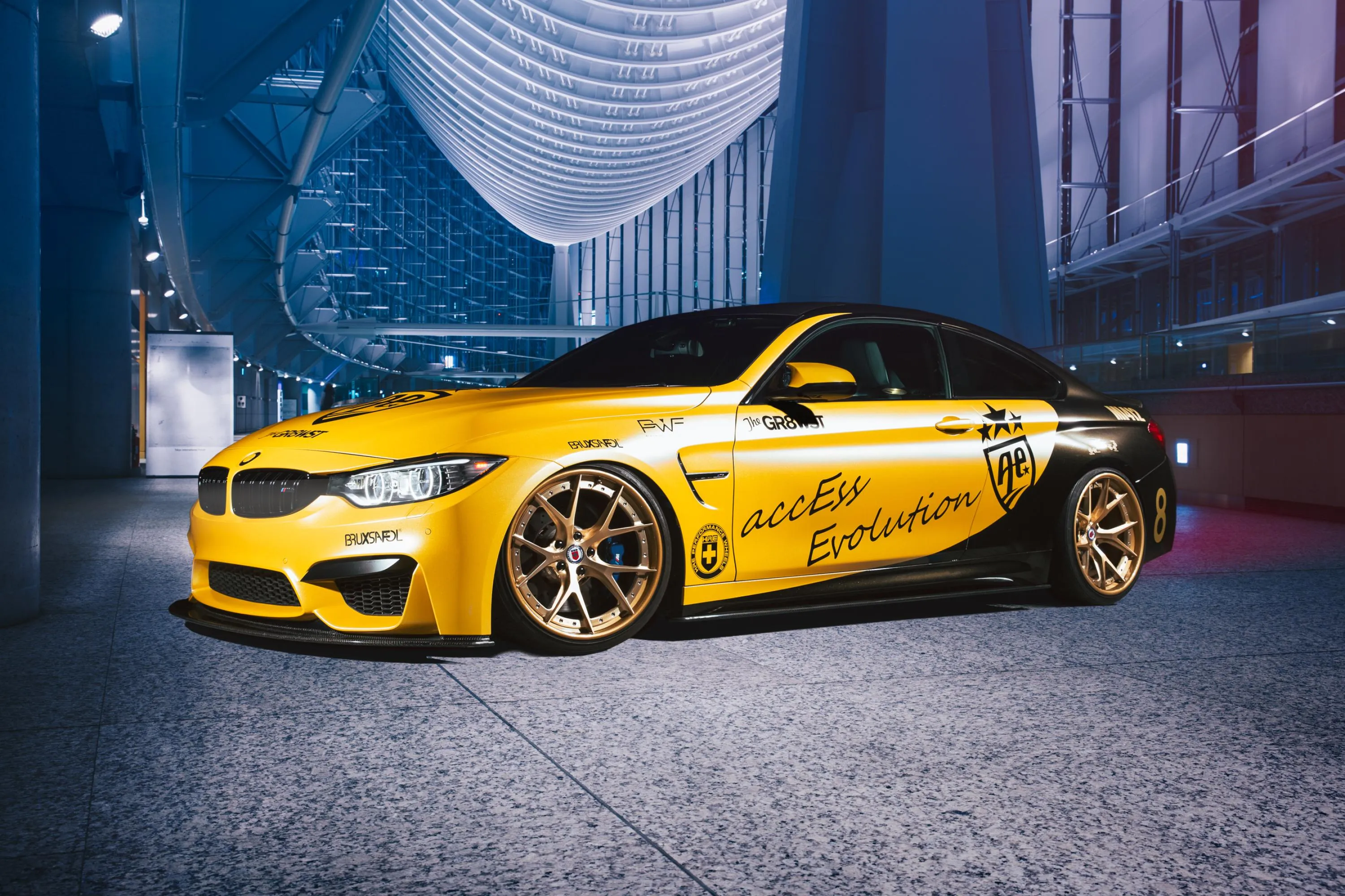 Vibrant Yellow Bmw Parked in Stylish City Setting Wallpaper