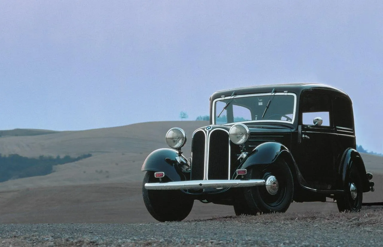 Vintage Black Bmw Car Displayed on Gravel with Blue Sky
