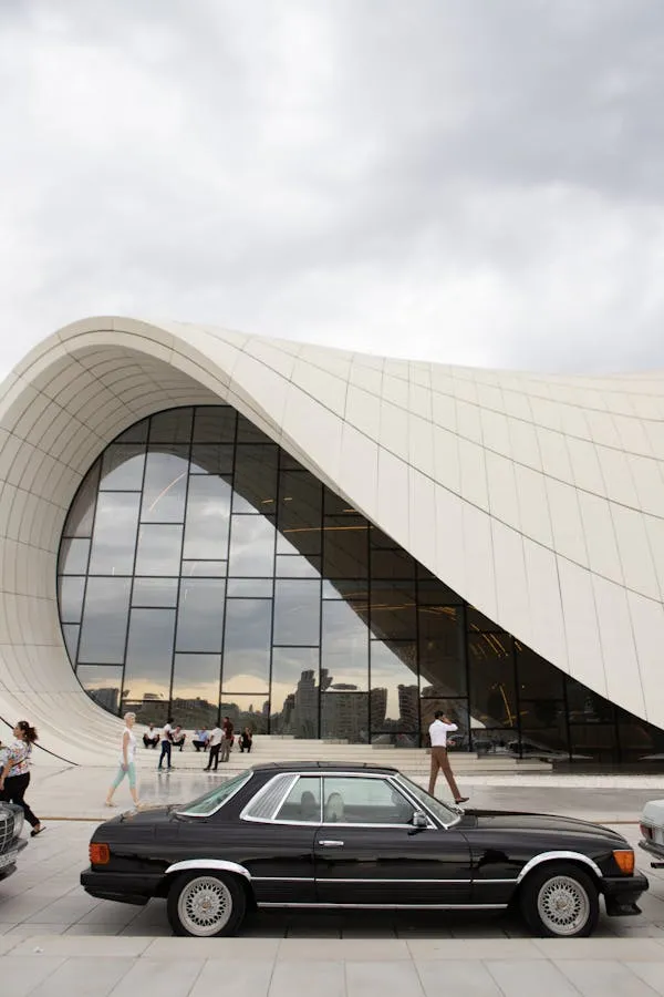 Vintage Black Mercedes Benz in Front of Modern Building 4K