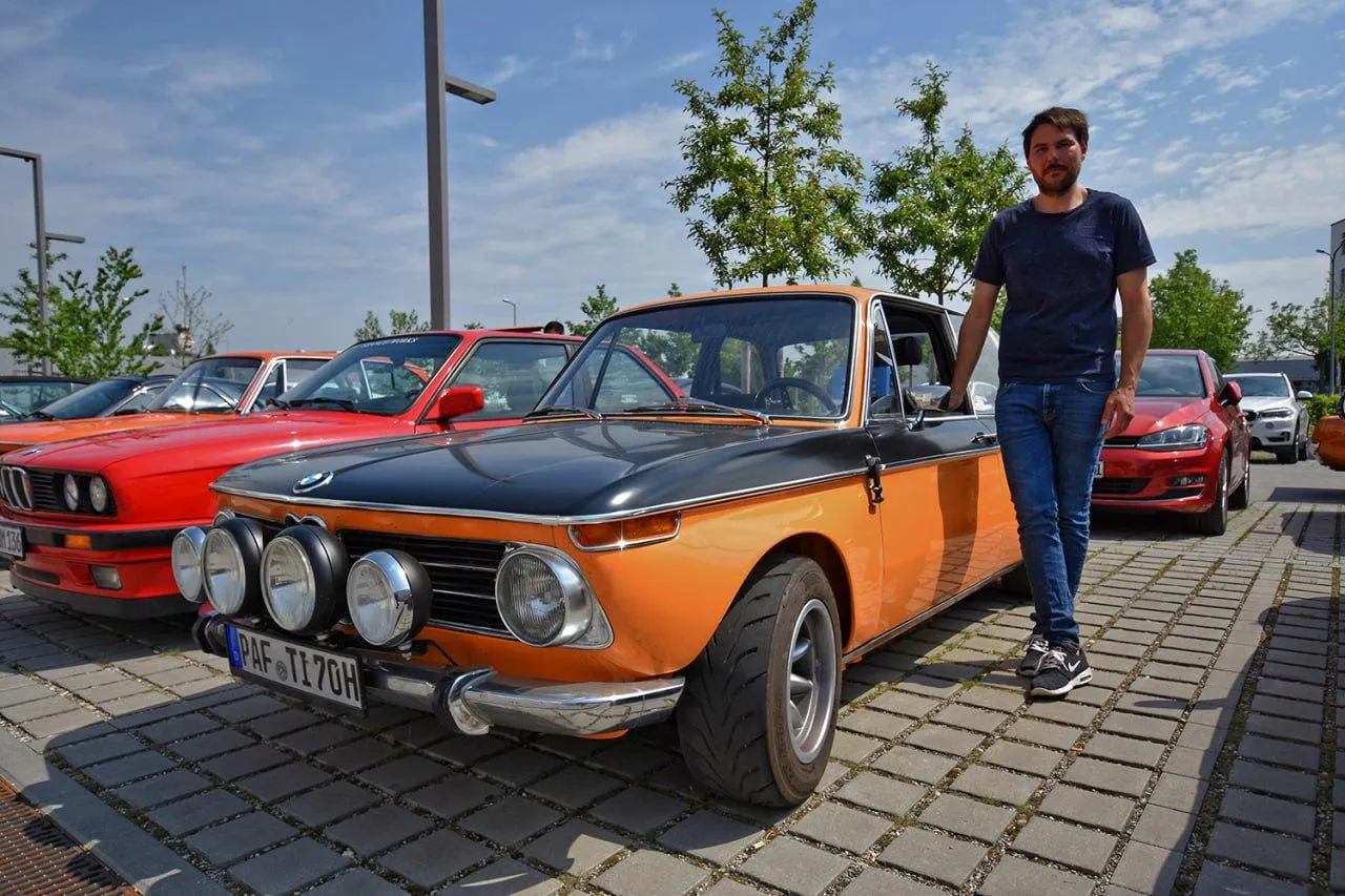 Vintage Bmw Car Parked with a Man Standing Nearby Wallpaper
