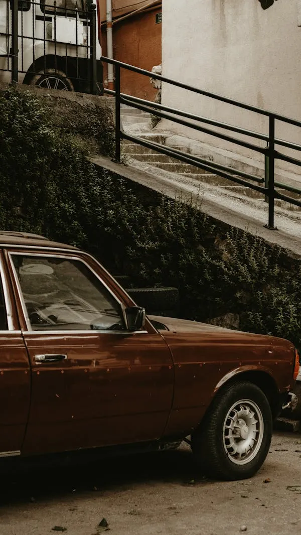 Vintage Maroon Mercedes Parked Beside Urban Staircase