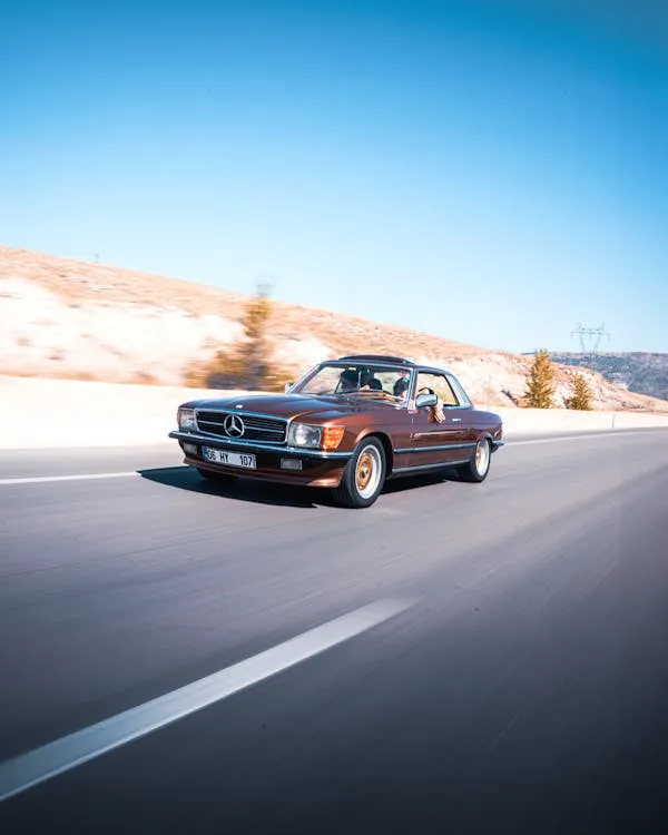 Vintage Mercedes Benz Driving Fast on Highway with Motion Blur