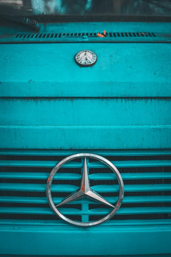 Vintage Mercedes Benz Emblem on Turquoise Vehicle Grill