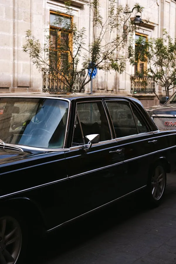 Vintage Mercedes Benz on Classic City Sidewalk Wallpaper