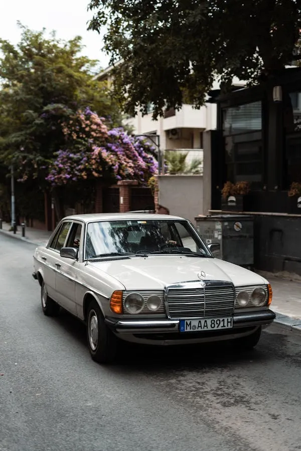 Vintage Mercedes driving through charming urban street