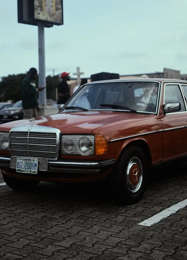 Vintage orange Mercedes car parked by the roadside