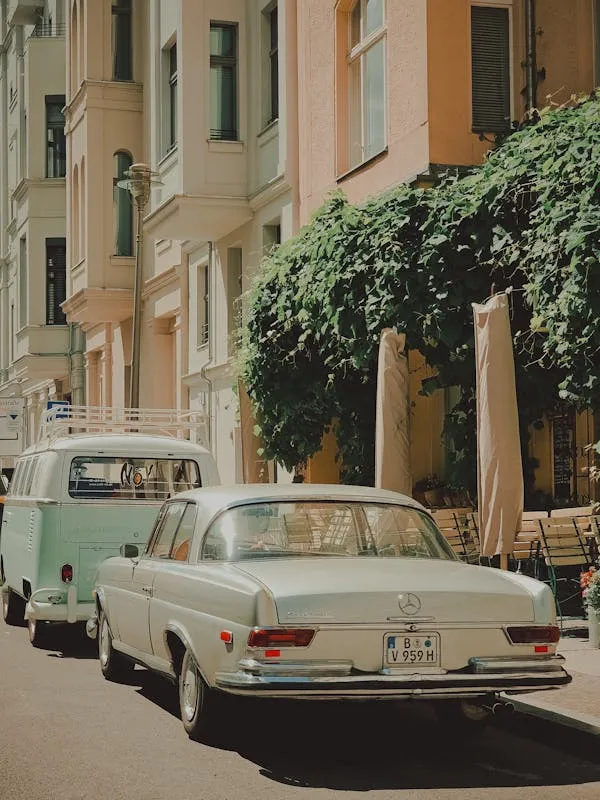 Vintage White Mercedes in European City Setting Wallpaper