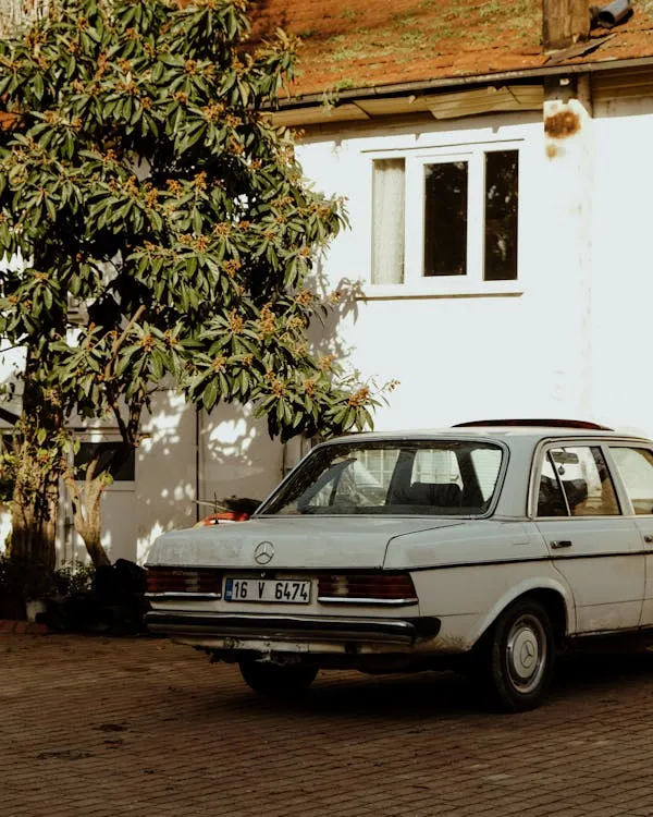 Vintage White Mercedes Parked in Quiet Residential Area
