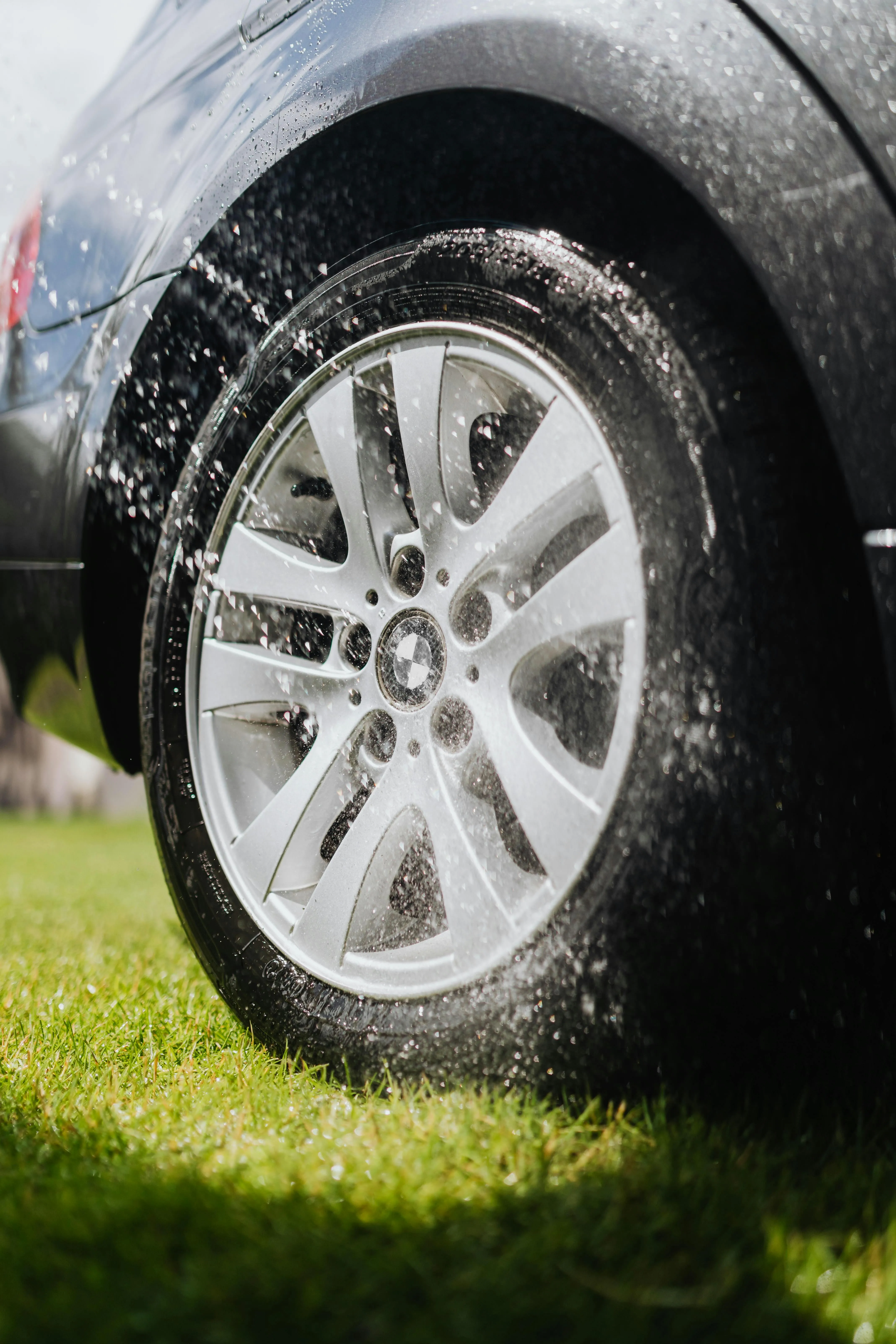 Water Sprayed on Bmw Wheel During Outdoor Wash Image