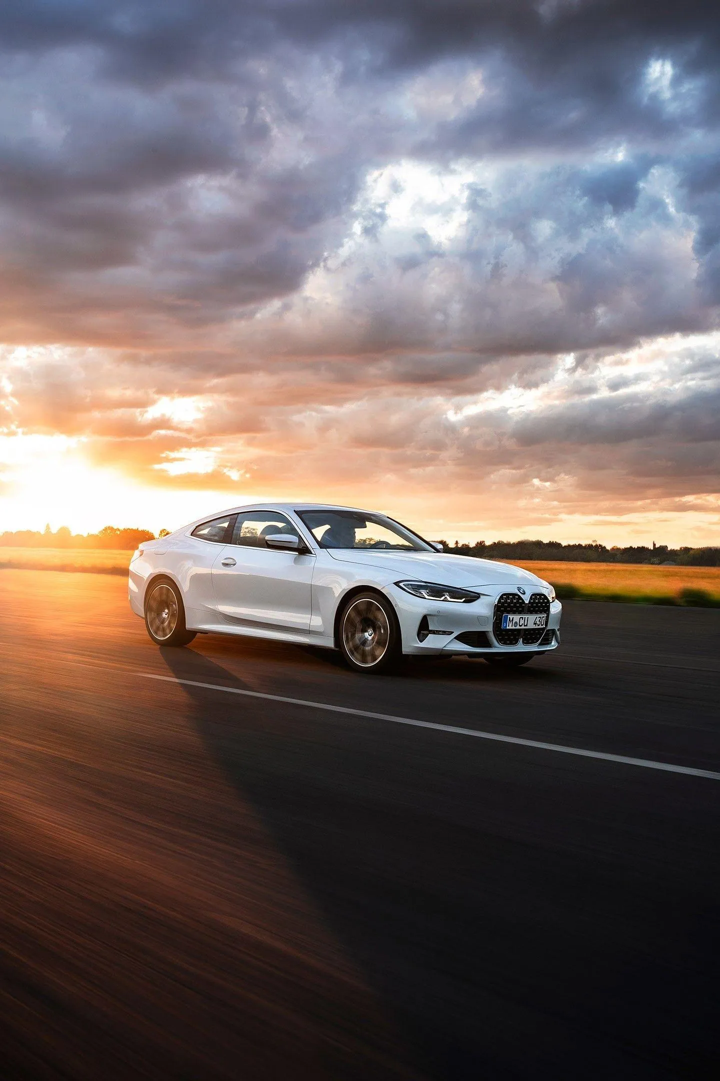 White Bmw Car Driving at Sunset on an Open Road Wallpaper